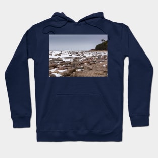 Rocks and snow on the coast of frozen sea Hoodie